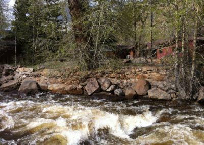 Storybook Exploration Cabin is an Extraordinary Mountain Town Vacation Home in Estes Park CO USA near Rocky Mountain National Park. This is an image of the Big Thompson River flowing across the road.