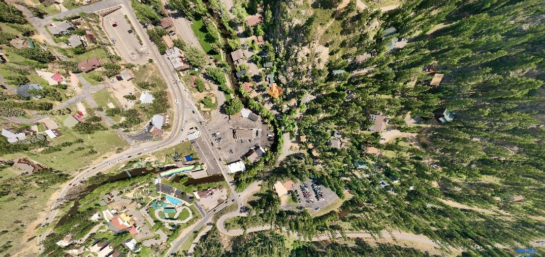 This is an aerial image of the Big Thompson River as it enters Historic Downtown Estes Park. This Mountain Life Basecamp - Redemption, Exploration and Redemption Cabins - are marked with the orange diamond. 